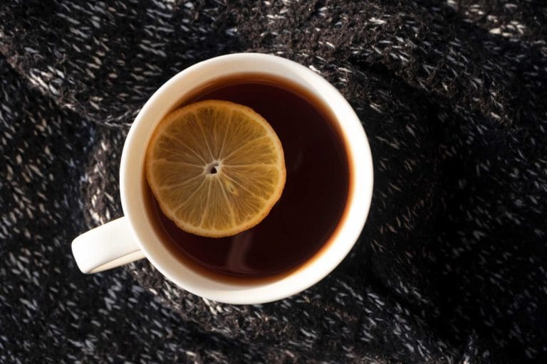 cup of earl grey tea with a lemon slice in it
